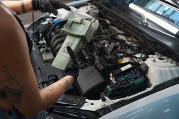 Auto repairman uses a special scanner in his work