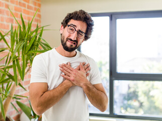 young adult crazy man with expressive pose at a modern house interior