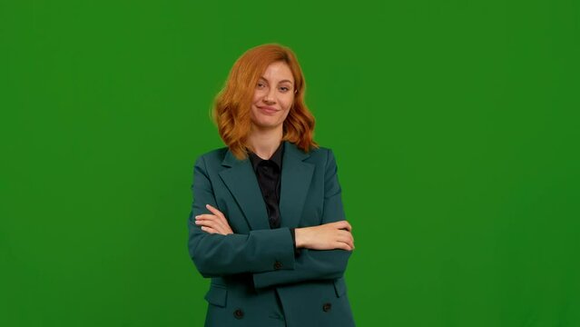 I am watching you gesture done by caucasian woman in green screen background studio. Pointing at her eyes and camera, shows spying on someone.