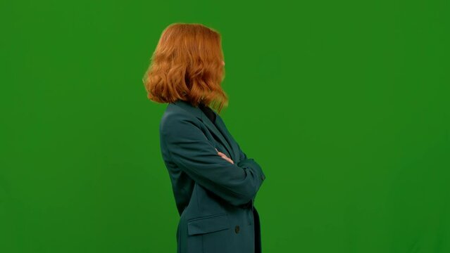 Rude woman shows fuck you in studio while feeling angry. Indecent hand gesture and insult with an unhappy female showing anger on chromakey mockup background.