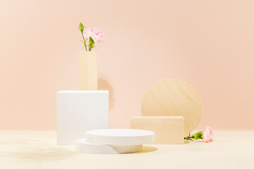 Empty podiums with tender flowers and geometric shapes. Product display on pastel pink background for presentation beauty products. Scene stage showcase for cosmetics and promotion sale