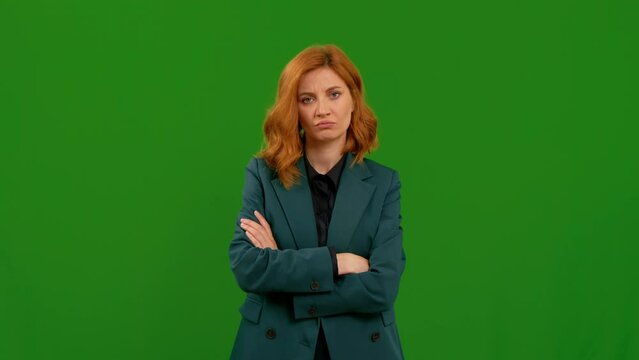 Pretty woman not interested in conversation crossing arms over green screen background. Disapproval from confident caucasian female.