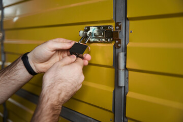 Close-up photo of man hands opening the lock