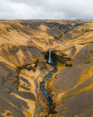 Kvernufoss waterfall in a mountain gorge. The amazing nature of Iceland. Wallpaper background of...