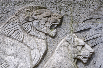 A stone slab carved with a lion pattern