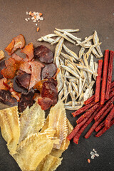 variety of dried fish, snacks for beer on a dark background. place for text, top view