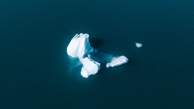 Icebergs drone aerial image top view - Climate Change and Global Warming. Icebergs from melting glacier. Arctic nature ice landscape in Unesco World Heritage Site.