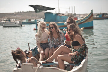 group of girls on a boat docked at the port