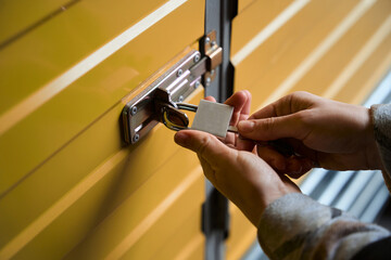 Close-up photo of a woman hands opening a lock