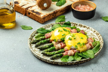 Eggs Benedict buttery hollandaise sauce, ham, poached eggs and green asparagus