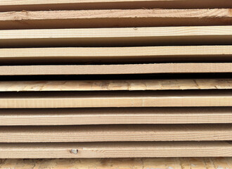 Obraz premium Wooden planks of wood stacked up to dry