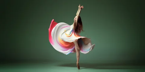 Abwaschbare Fototapete Portrait with one young woman, classic dancer dancing in colorful painted dress over dark green background. Contemporary dance style, ballet © Lustre
