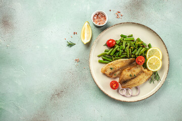 Baked white fish fillet Pangasius or tilapia with vegetables. banner, menu, recipe place for text, top view