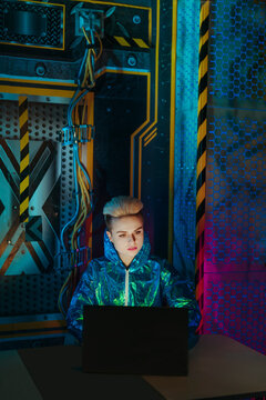 Gamer using laptop sitting at desk