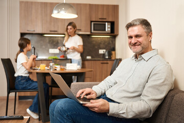 Happy man with his family together in the morning in a hotel room
