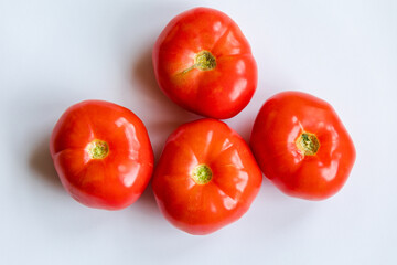 bunch of red tomatoes close up on white background