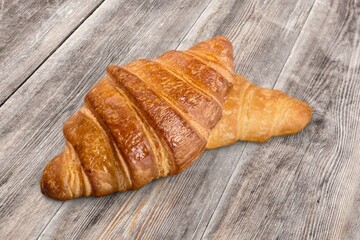 Appetizing fresh tasty croissant on desk