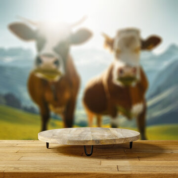 Desk of free space and blurred landscape with cows. 