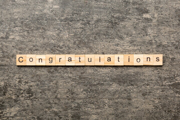 congratulations word written on wood block. congratulations text on cement table for your desing,...