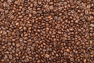 Heap of fresh roasted coffee beans on the table. Top view.