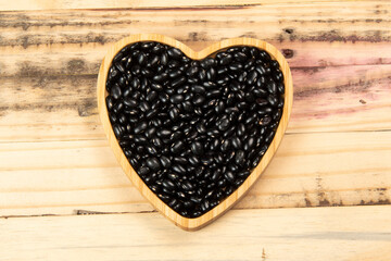 heart shaped black bean bowl on wooden table