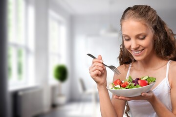Diet concept, young woman eat vegetables salad