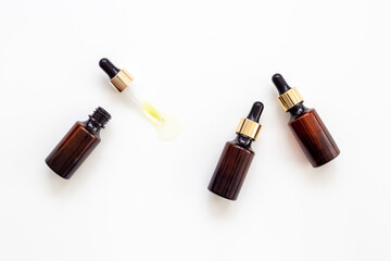 Cosmetic products concept - face serum essential oil in dropper bottle