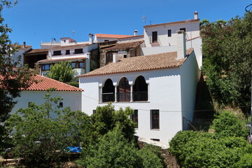 Fototapeta na wymiar Fuenteheridos, Huelva, Spain, April 26, 2023: Typical white houses with terraces with arches of Fuenteheridos, Huelva, Spain