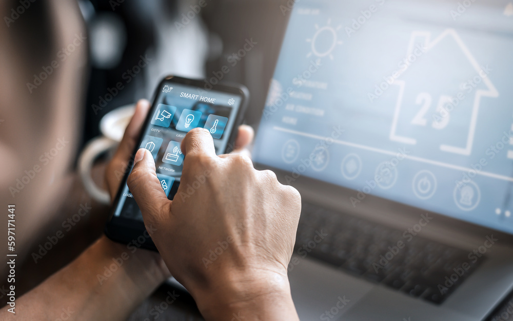 Poster young man using smart phone and notebook computer while working from home; interior of man using sma