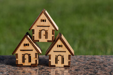 Miniature wooden houses on the background of the lawn on a sunny day