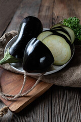 Raw and uncooked eggplant on wooden table background