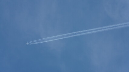 The clear sky view with an airplane flying in the sky 