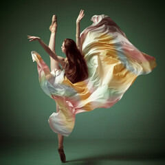 One young adorable professional ballet dancer wearing colorful dress dancing over dark green background. Modern ballet with silk dress © Lustre Art Group 