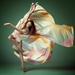Portrait of inspired young ballerina, beautiful girl wearing silk dress and dancing with emotion over dark green background © Lustre Art Group 