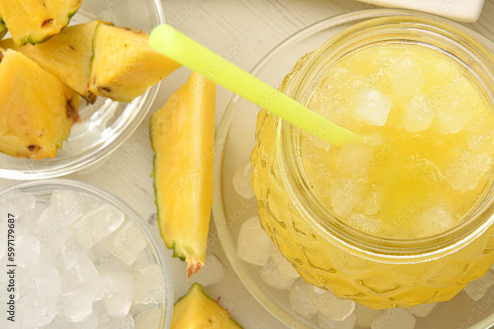 Wall mural detail of jar with cold pineapple drink and cut fruit