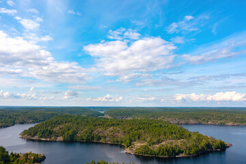Republic of Karelia. Russia nature. Islands in lake Ladoga. Russian forest aerial view. Blue sky over Karelia. Coniferous taiga. Northern nature. Panorama of Karelia. Lakes of Russia. Tourism, travel