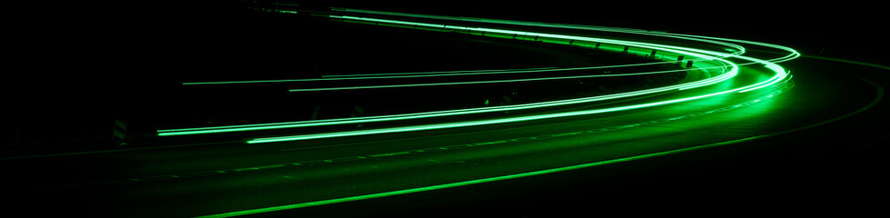 green car lights at night. long exposure