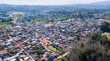 Aerial view of a small town between mountains.