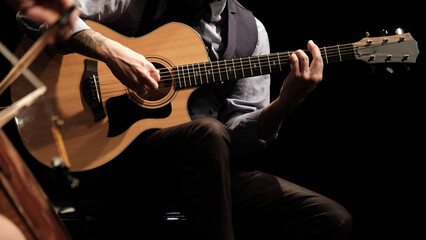 man playing guitar in the spotlight