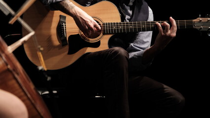 man playing guitar in the spotlight