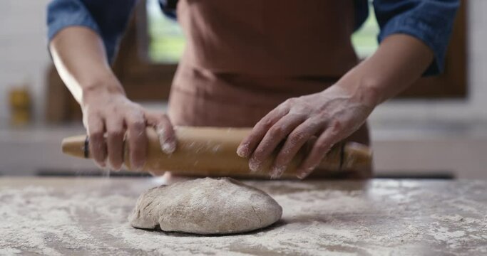 Woman hands kneading dough in the kitchen