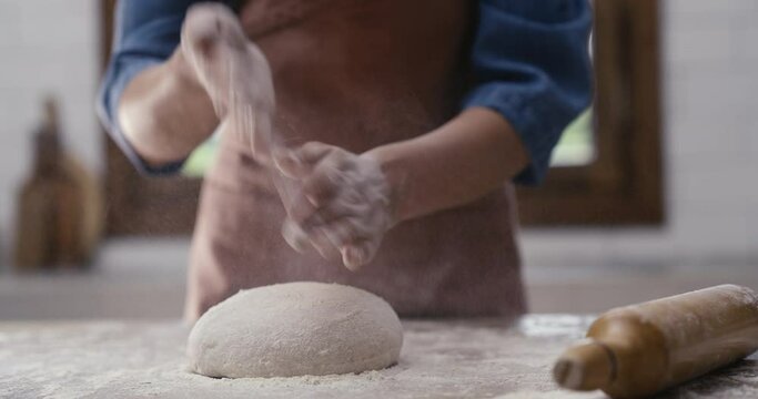 Woman hands kneading dough in the kitchen