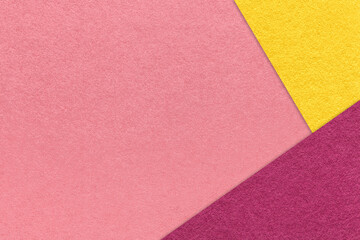Texture of craft dark pink color paper background with yellow and purple border. Vintage abstract rose cardboard.