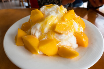 eating mango shaved ice