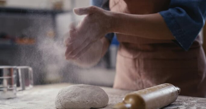 Woman hands kneading dough in the kitchen
