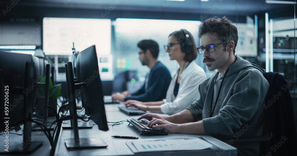 Poster Portrait of a Focused Computer Engineer Working in a Technological Office Facility. Research and Development Department Writing Software Code for an Innovative Online Program for a Global Enterprise