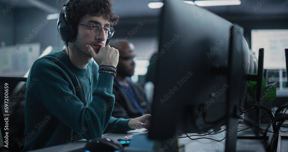 Aufkleber Portrait of a Thoughtful Engineer Working on Desktop Computer in a Technological Office Environment. Research and Development Department Writing Software Code for an Advanced Neural Network Project