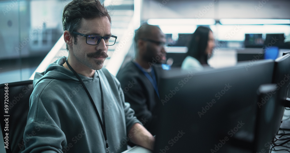 Poster Portrait of a Thoughtful Engineer Working on Desktop Computer in a Technological Office Environment. Research and Development Department Writing Software Code for an Advanced Neural Network Project