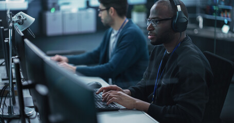 African American QA Engineer Finds and Fixes Bugs in a Product or Program Before the Launch,...