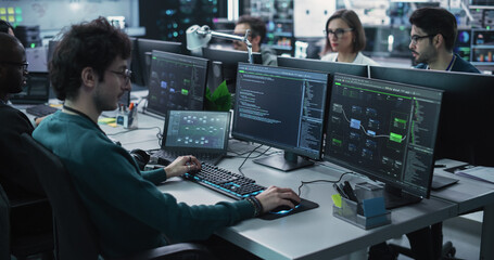 Team of Diverse Multiethnic Software Developers Working on Computers, Programming Advanced Code,...